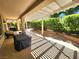 Expansive covered patio with a pergola, lush hedges, and outdoor seating at 2809 Winslow Springs Dr, Henderson, NV 89052