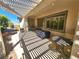 Spacious covered patio with modern patio furniture, grill and beautiful landscaped backyard at 2809 Winslow Springs Dr, Henderson, NV 89052
