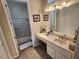 Bathroom area showcasing a sink, bathtub, shower combo and a well lit mirror at 2809 Winslow Springs Dr, Henderson, NV 89052