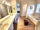 A bright bathroom features double sinks, a soaking tub, and tile flooring at 2809 Winslow Springs Dr, Henderson, NV 89052