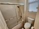 Bathroom area with shower/tub combo, toilet, and tile flooring at 2809 Winslow Springs Dr, Henderson, NV 89052