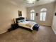 Bedroom with vaulted ceiling, ceiling fan, carpet flooring, and lots of natural light at 2809 Winslow Springs Dr, Henderson, NV 89052