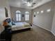 Bedroom showcasing carpet floors, a ceiling fan, and two large arched windows at 2809 Winslow Springs Dr, Henderson, NV 89052