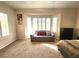 Charming sitting area in main bedroom with bay window, shutters, and cozy love seat at 2809 Winslow Springs Dr, Henderson, NV 89052