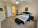 Spacious bedroom featuring carpet floors, ceiling fan, neutral walls and ensuite bathroom entrance at 2809 Winslow Springs Dr, Henderson, NV 89052