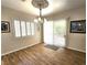 Bright dining area featuring wood-look tile flooring, window shutters, and an ornate chandelier at 2809 Winslow Springs Dr, Henderson, NV 89052