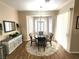 Charming dining area with a round table, neutral decor, and a bay window with natural light at 2809 Winslow Springs Dr, Henderson, NV 89052