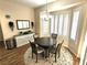 Bright dining area featuring neutral tones, modern chandelier, and bay window with natural lighting at 2809 Winslow Springs Dr, Henderson, NV 89052