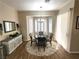 Charming dining area with a round table, area rug, plantation shutters, and neutral decor at 2809 Winslow Springs Dr, Henderson, NV 89052