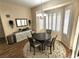Cozy dining room featuring a round table, elegant chandelier, and plantation shutters for natural light at 2809 Winslow Springs Dr, Henderson, NV 89052