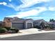 Spacious single-story home featuring a tile roof, stucco walls, desert landscaping, and a convenient three-car garage at 2809 Winslow Springs Dr, Henderson, NV 89052