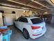View of the spacious two-car garage featuring ample storage and an off-road, all-terrain vehicle at 2809 Winslow Springs Dr, Henderson, NV 89052