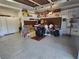 Spacious two-car garage featuring storage shelves and room for two cars or a workshop area at 2809 Winslow Springs Dr, Henderson, NV 89052
