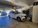 Two-car garage with epoxy floor, vehicle, storage racks, and plenty of space for cars and other items at 2809 Winslow Springs Dr, Henderson, NV 89052