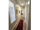 Hallway with wood look tile flooring, featuring art, and lots of natural light at 2809 Winslow Springs Dr, Henderson, NV 89052