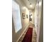 Inviting hallway with wood-look tile flooring and natural light filtering through the window at 2809 Winslow Springs Dr, Henderson, NV 89052