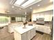 Bright kitchen boasts a center island, stainless steel appliances, and white cabinetry for ample storage at 2809 Winslow Springs Dr, Henderson, NV 89052