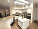 Spacious kitchen featuring white cabinets, stainless steel appliances, an island, tiled backsplash, and a breakfast bar at 2809 Winslow Springs Dr, Henderson, NV 89052