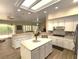 Bright kitchen features an island with white cabinets and countertops, complemented by modern stainless steel appliances at 2809 Winslow Springs Dr, Henderson, NV 89052
