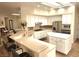 Well-lit kitchen with white cabinets, a center island, stainless steel appliances, and breakfast bar seating at 2809 Winslow Springs Dr, Henderson, NV 89052