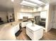 Well-lit kitchen with white cabinets, a center island, stainless steel appliances, and breakfast bar seating at 2809 Winslow Springs Dr, Henderson, NV 89052