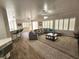 Spacious living room with a comfortable couch, tile floors, and plantation shutters at 2809 Winslow Springs Dr, Henderson, NV 89052