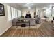 Spacious living room with carpet and tile flooring, large windows, and modern furnishings at 2809 Winslow Springs Dr, Henderson, NV 89052
