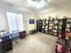 Cozy living room featuring modern shelving and a well-lit workspace near the window at 2809 Winslow Springs Dr, Henderson, NV 89052
