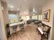 Open-concept living area with breakfast bar, couch, wood-look tile floors, and neutral tones at 2809 Winslow Springs Dr, Henderson, NV 89052