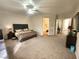 Spacious main bedroom with a comfy bed, ceiling fan, carpet and ensuite bath access at 2809 Winslow Springs Dr, Henderson, NV 89052