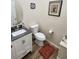 Neat powder room showcasing a modern vanity, toilet, and framed artwork with tiled flooring at 2809 Winslow Springs Dr, Henderson, NV 89052
