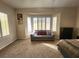 Sitting area in bedroom with natural light and carpeted floors at 2809 Winslow Springs Dr, Henderson, NV 89052