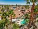 Beautiful backyard featuring a sparkling pool, covered patio, and lush tropical landscaping for ultimate relaxation at 2909 Sterling Cove Dr, Las Vegas, NV 89128