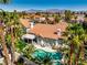 Tropical backyard with a freeform pool, lush landscaping, and outdoor seating, ideal for relaxation and entertaining at 2909 Sterling Cove Dr, Las Vegas, NV 89128