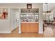 Charming bar area with custom cabinetry, mirrored backsplash, and seamless access to the living room at 2909 Sterling Cove Dr, Las Vegas, NV 89128