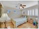 Comfortable bedroom with a ceiling fan, windows with shutters, wood-look floors, and neutral paint at 2909 Sterling Cove Dr, Las Vegas, NV 89128