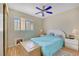 Inviting bedroom featuring wood-look floors, a ceiling fan, shutters, and comfortable furnishings at 2909 Sterling Cove Dr, Las Vegas, NV 89128