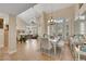 Bright dining area with high ceilings, chandelier, plantation shutters, and wood floors at 2909 Sterling Cove Dr, Las Vegas, NV 89128