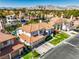 Beautiful two-story home featuring a red tile roof and well-maintained front yard with lush green grass at 2909 Sterling Cove Dr, Las Vegas, NV 89128