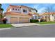 Charming home with a two-car garage, tile roof, well-maintained lawn, and mature landscaping at 2909 Sterling Cove Dr, Las Vegas, NV 89128