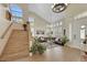 Grand foyer with vaulted ceiling, wood staircase, and views of the spacious living area at 2909 Sterling Cove Dr, Las Vegas, NV 89128