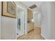 Bright hallway showcasing wood-look floors, storage cabinets, and doorways leading to other areas of the home at 2909 Sterling Cove Dr, Las Vegas, NV 89128