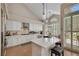 Updated kitchen featuring a large island, white cabinetry, stainless appliances, and modern pendant lighting at 2909 Sterling Cove Dr, Las Vegas, NV 89128