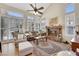 Cozy living room featuring a stone fireplace, plantation shutters, and ample natural light at 2909 Sterling Cove Dr, Las Vegas, NV 89128