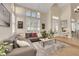 Spacious living room features large windows, vaulted ceilings, and a comfortable sectional sofa at 2909 Sterling Cove Dr, Las Vegas, NV 89128