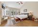 Main bedroom with vaulted ceiling, fireplace, light wood floors, and French doors to pool area at 2909 Sterling Cove Dr, Las Vegas, NV 89128