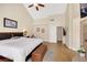 Main bedroom with vaulted ceiling, light wood floors, fireplace, and access to ensuite bathroom at 2909 Sterling Cove Dr, Las Vegas, NV 89128