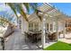 Covered patio with outdoor dining and seating areas for entertaining, tropical palms, BBQ at 2909 Sterling Cove Dr, Las Vegas, NV 89128