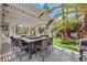 Covered patio with outdoor dining table, BBQ grill, and backyard views at 2909 Sterling Cove Dr, Las Vegas, NV 89128