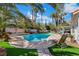 Backyard pool featuring mature palms, spa, and ample space for entertaining and relaxing at 2909 Sterling Cove Dr, Las Vegas, NV 89128